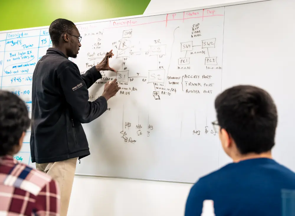 man writing on whiteboard 