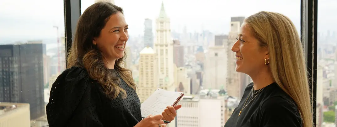 Two people in front of NYC skyline