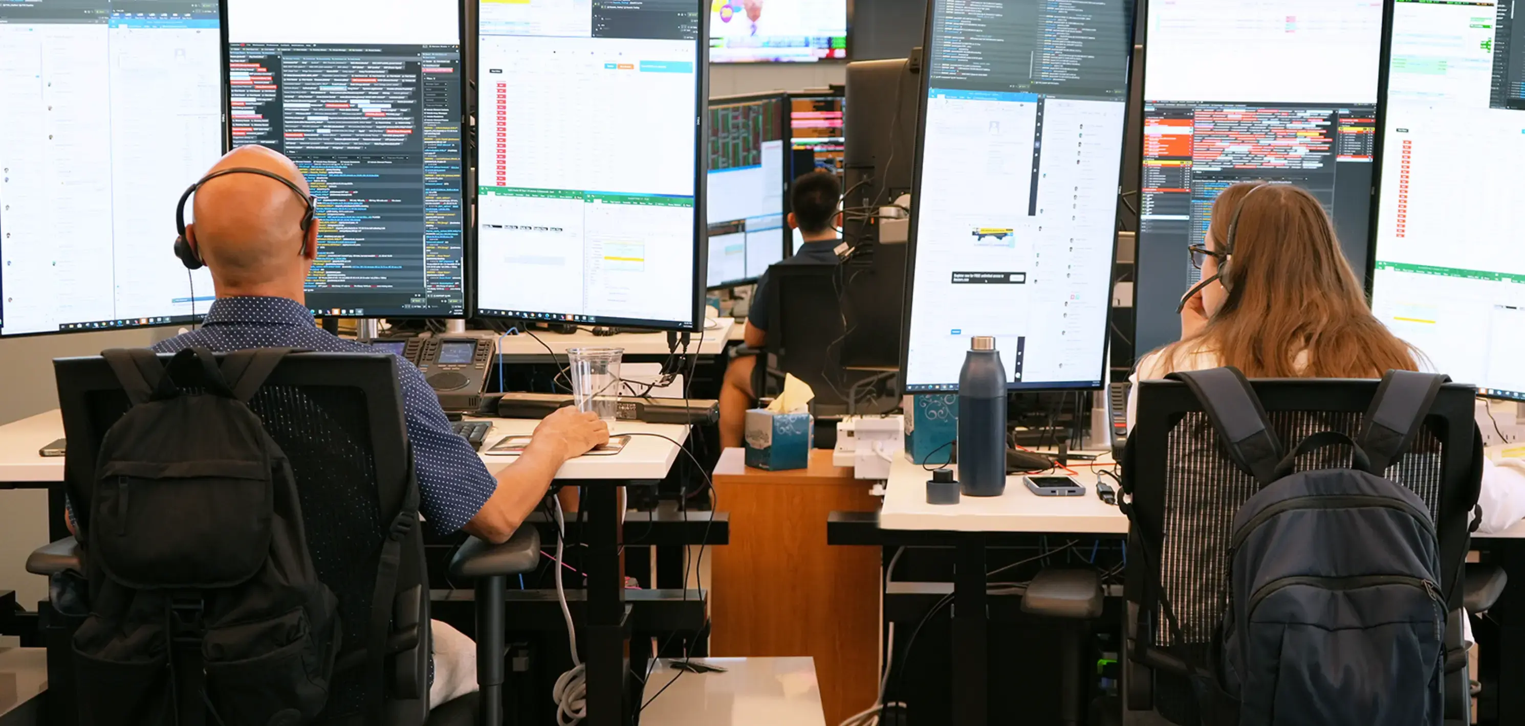 Two traders sitting at their desks