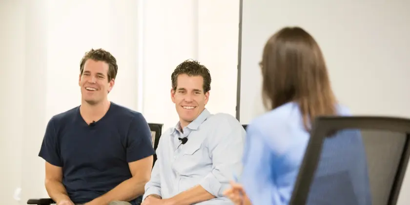 brothers sitting laughing talking to woman