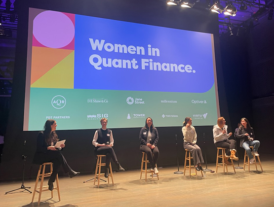 People on stage doing a presentation on Women in Quant Finance