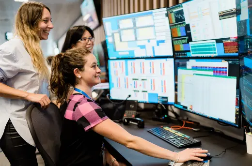 Three women at a trading desk