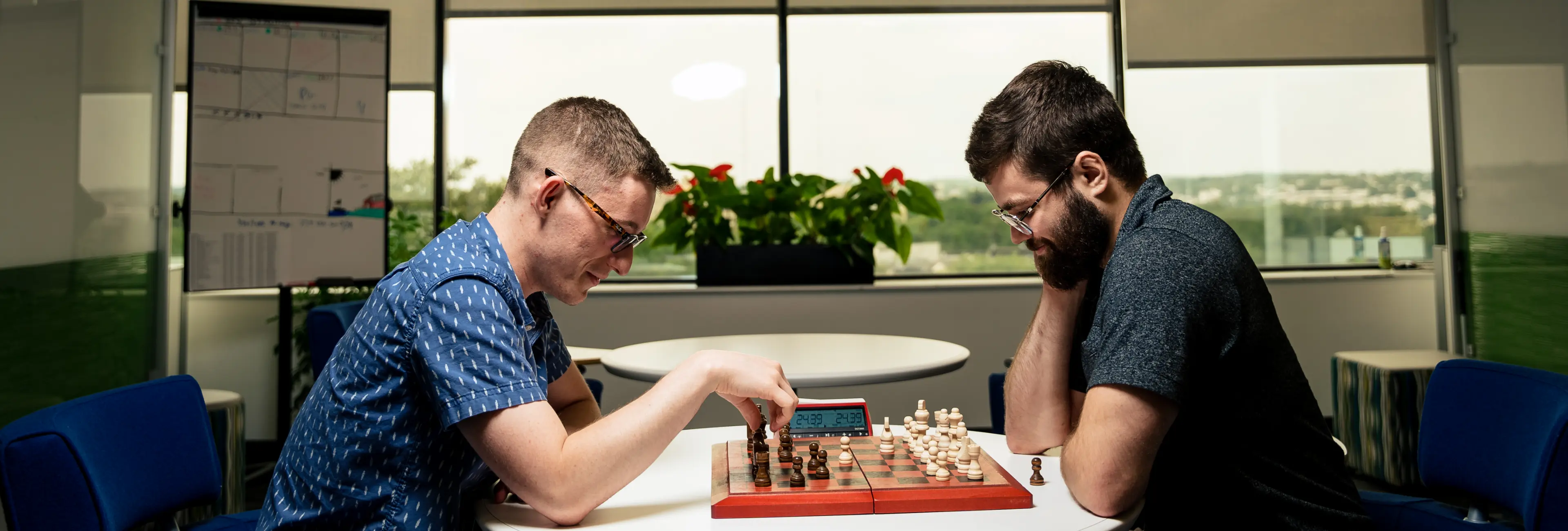 Two people playing chess at the office