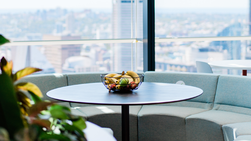 A table with a fruit bowl on top