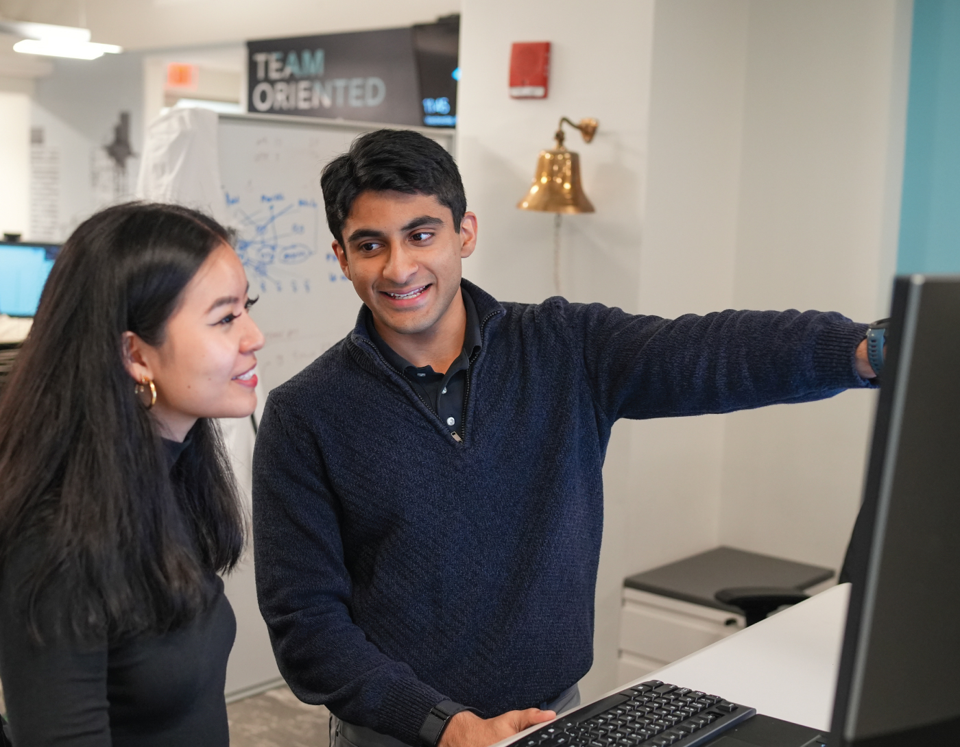 Two SGE members going over data on a computer