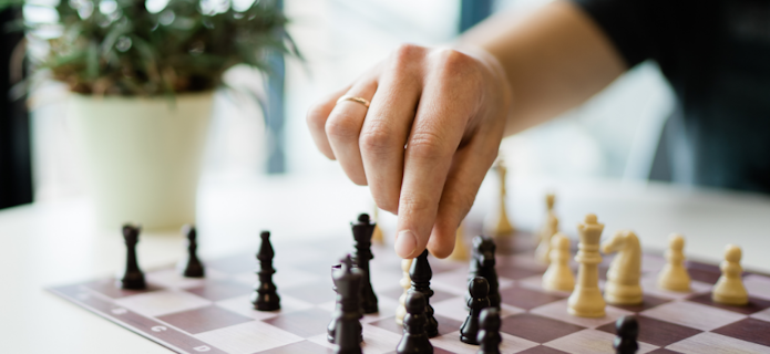 hand playing chess