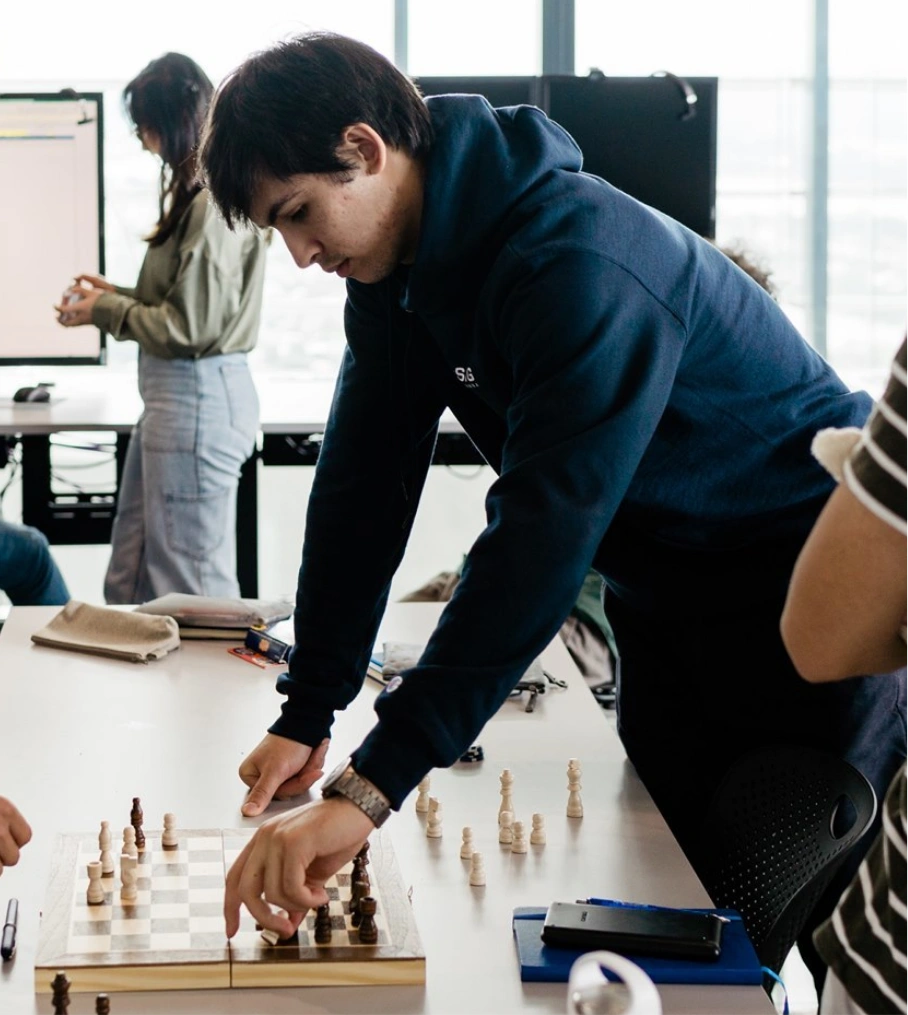 man standing playing chess (new 12/13)