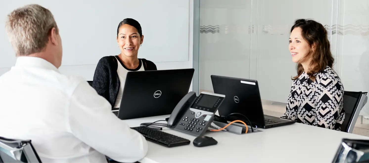 Three people meeting with laptops