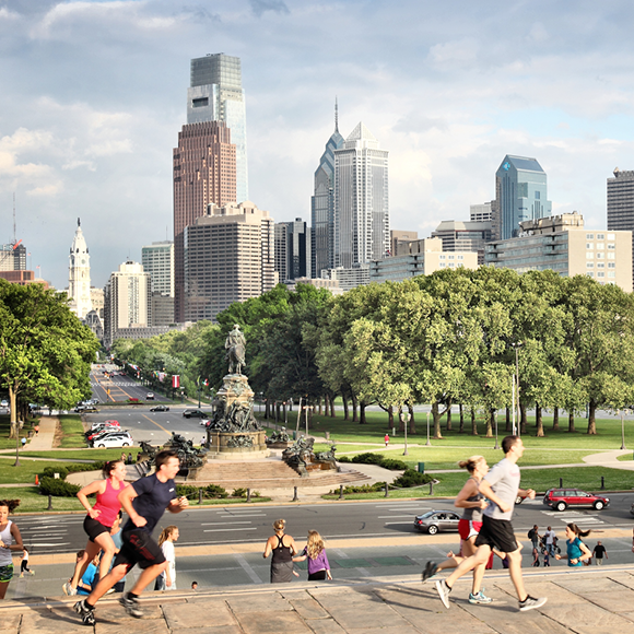 A photo overlooking some joggers on steps of the Philadelphia art museum