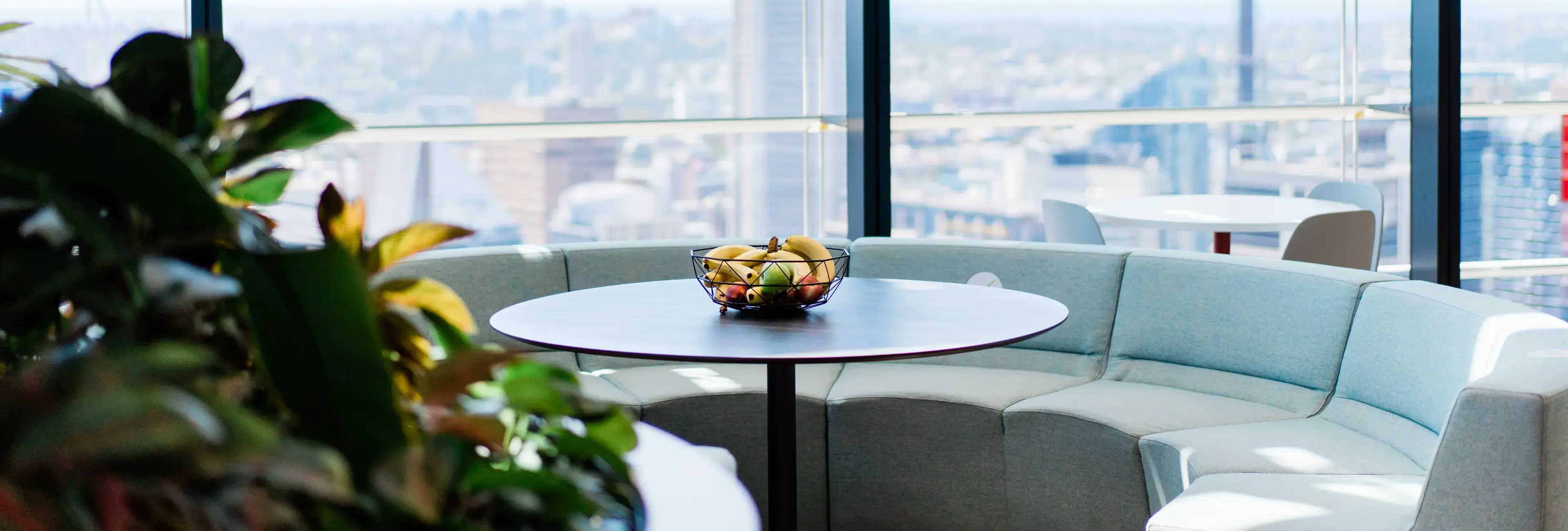 A table with a fruit bowl on top