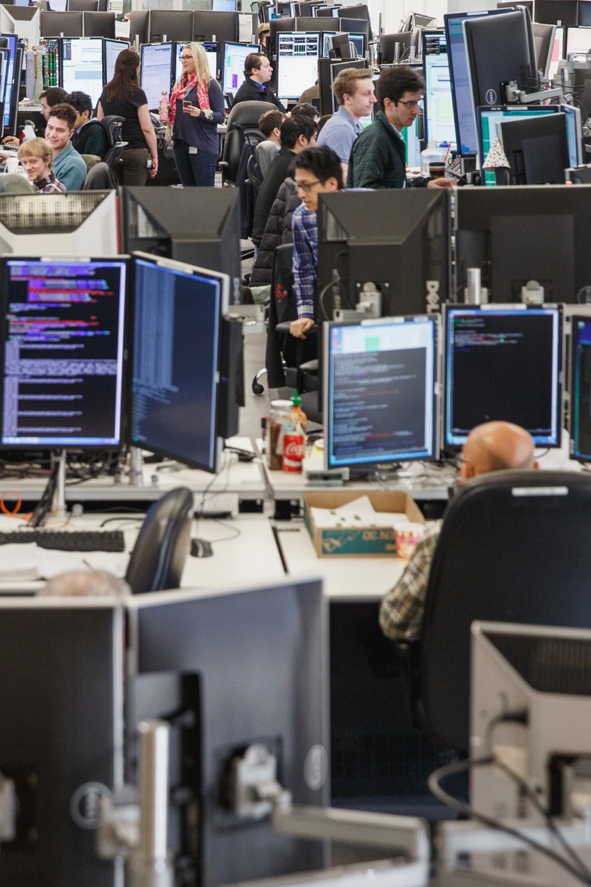 lots of monitors and desks on trading floor