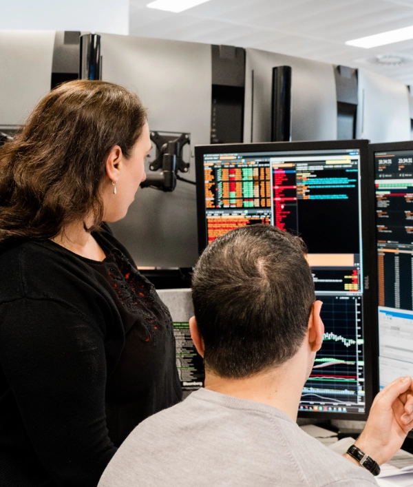 Two people working together and looking at a screen