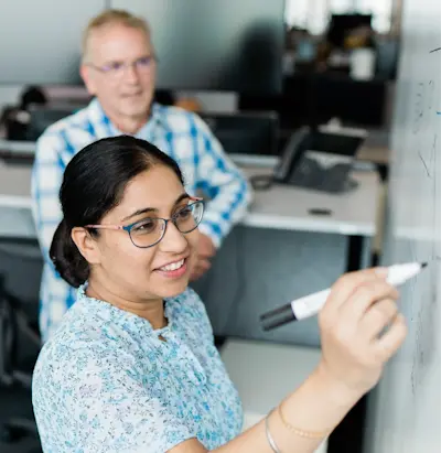 woman writing on whiteboard